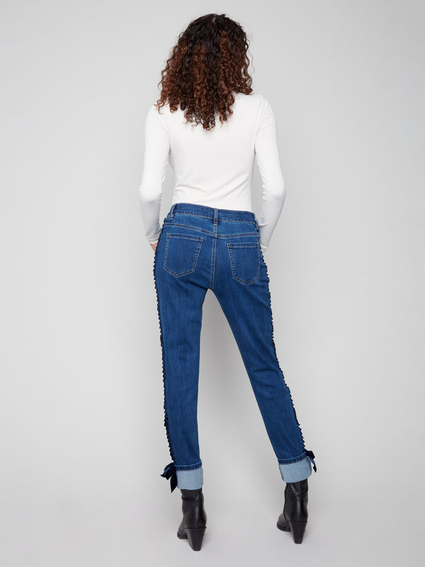 Stylish indigo jeans with a unique folded hem and slim leg design. Velvet bows add a touch of sophistication by Charlie B.