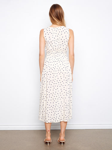 Back view of a polka dot dress with midi length and smocked waist for comfort by Charlie B.
