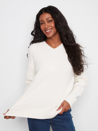 Soft boucle sweater in ecru with a classic V-neck design, emphasizing its cozy long sleeves for chilly days by Charlie B.