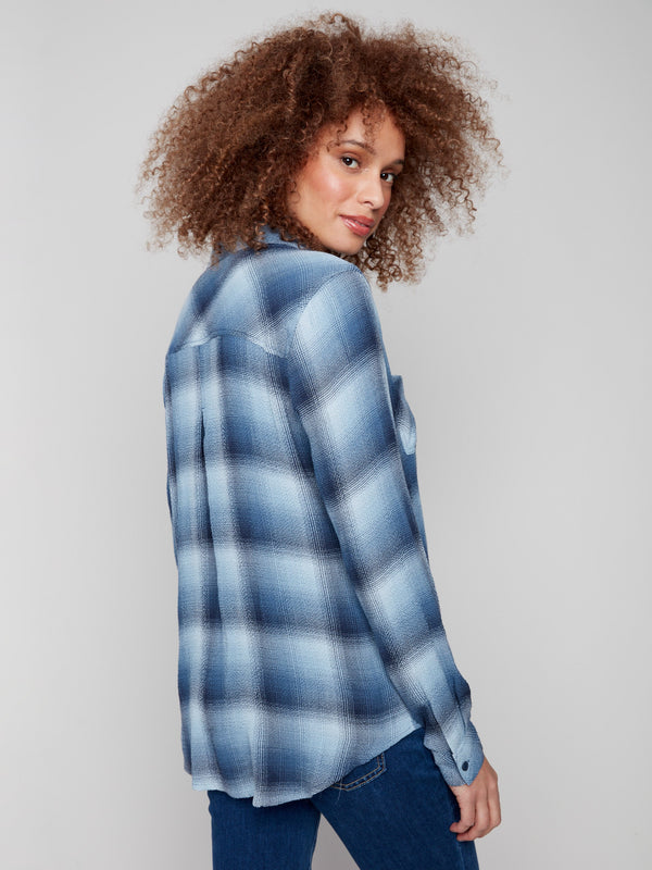 Chic button-down closure adds versatility to this blue plaid blouse by Charlie B.