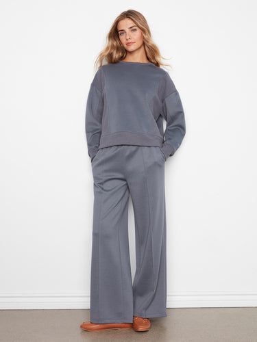 Relaxed fit top crafted in soft scuba fabric, featuring ribbed cuffs and hem for added style. By Charlie B.