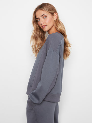 Stylish crew neck sweatshirt with ribbed side panels and cuffs, offering comfort in its relaxed fit. By Charlie B.