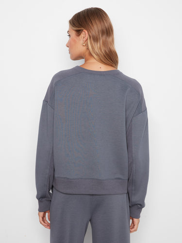 Elegant long-sleeved top made from soft scuba fabric, complete with ribbed hem for a chic look. By Charlie B.