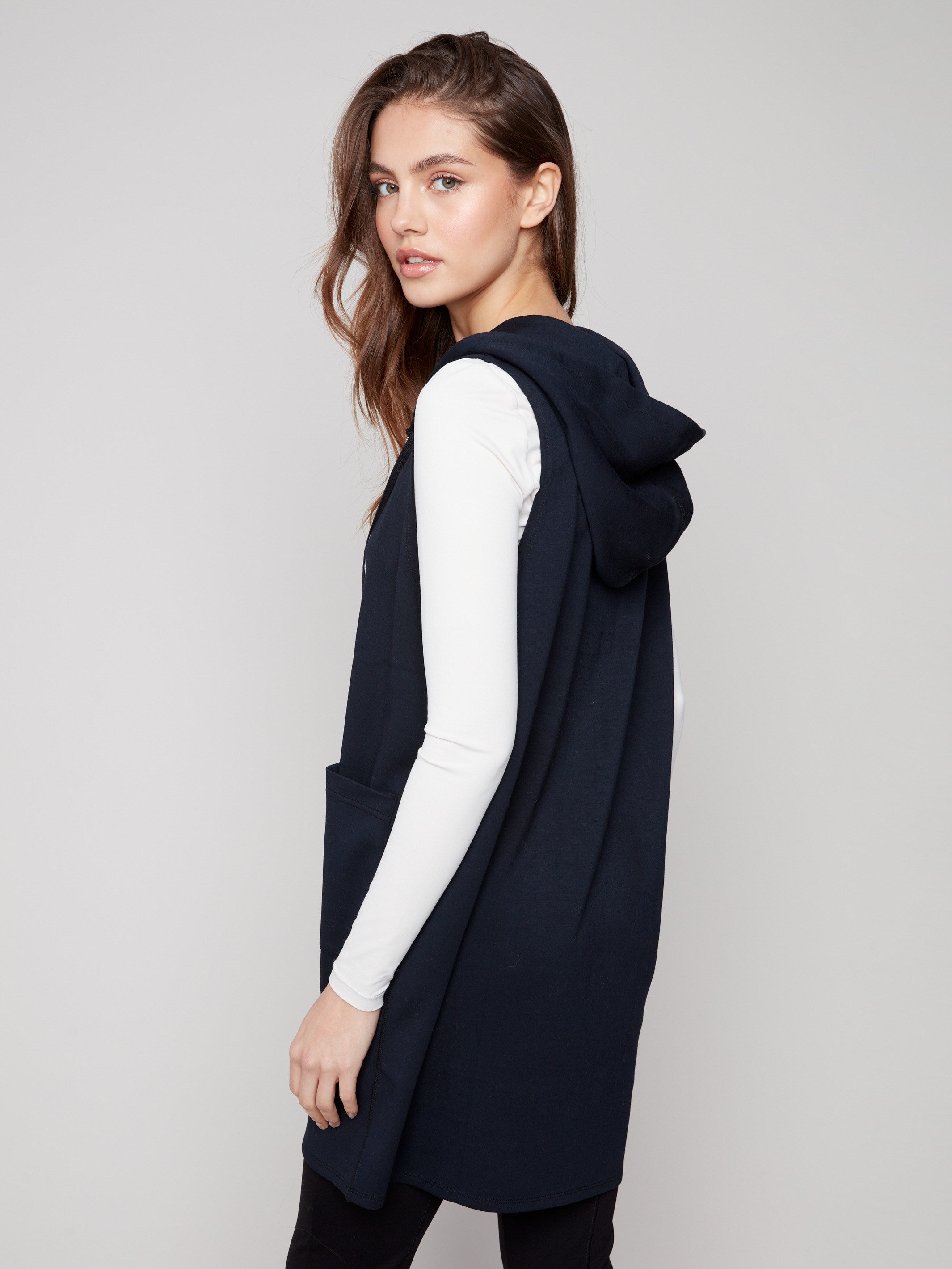 Elegant sleeveless vest in black with practical front patch pockets for added convenience by Charlie B.