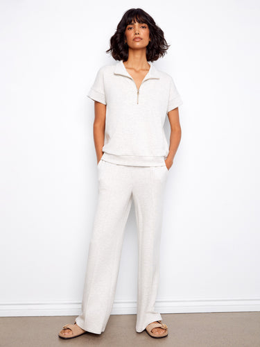 This chic light grey top showcases blanket stitch detail, enhancing its elegant design with short sleeves by Charlie B.