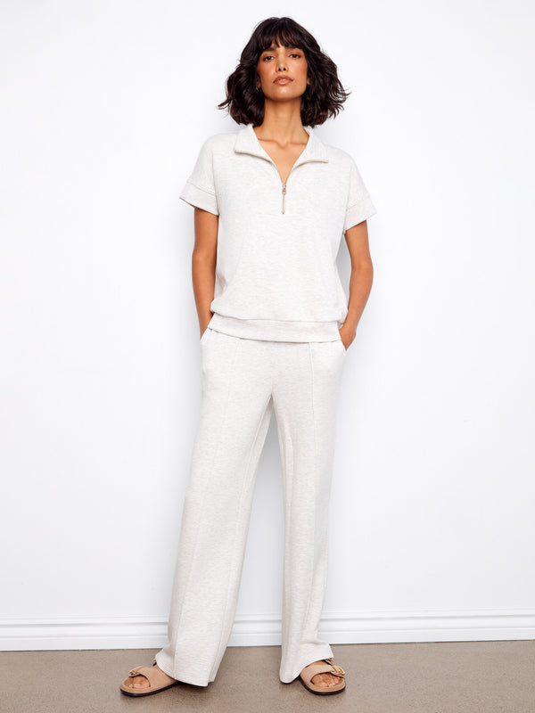 This chic light grey top showcases blanket stitch detail, enhancing its elegant design with short sleeves by Charlie B.