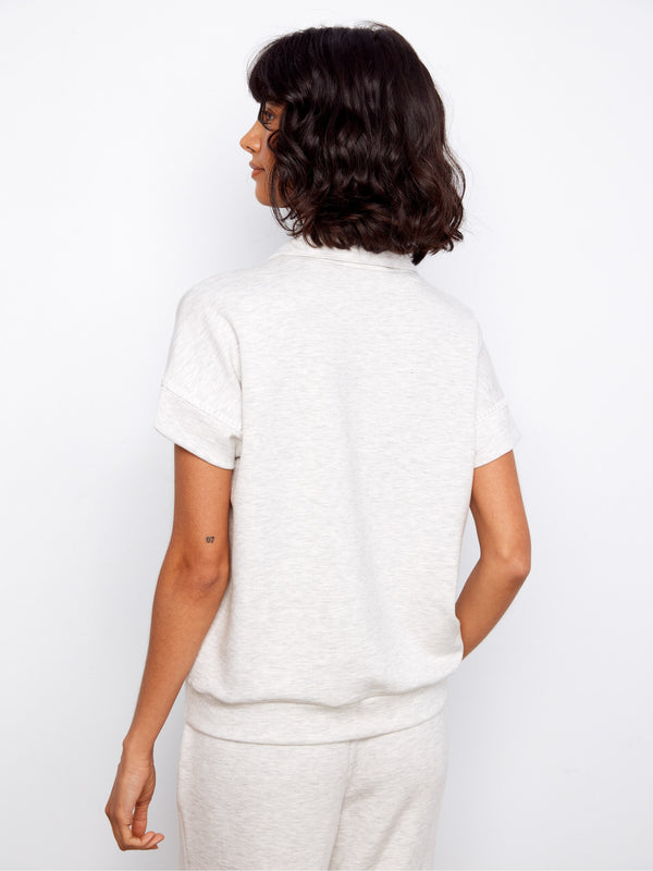 The versatile light grey top includes a cozy mock neckline, ideal for layering or wearing alone by Charlie B.