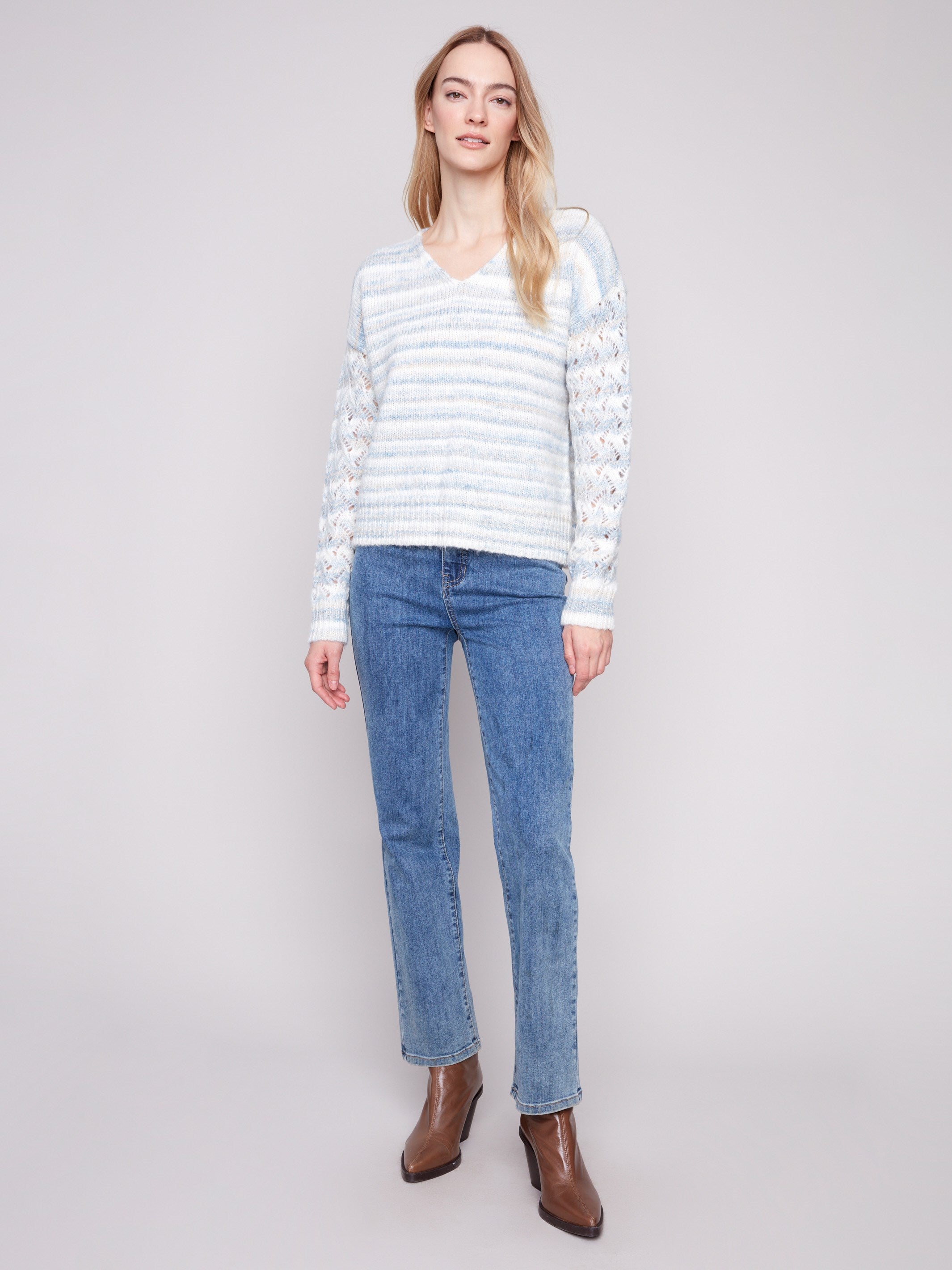 Chic women's sweater with open knit sleeves, showcasing a V-neck and space dye pattern in soft hues by Charlie B.