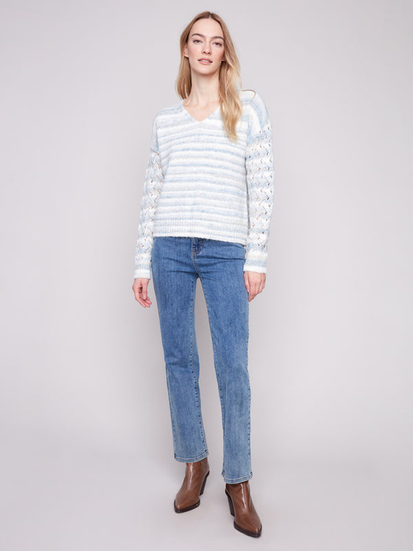 Chic women's sweater with open knit sleeves, showcasing a V-neck and space dye pattern in soft hues by Charlie B.