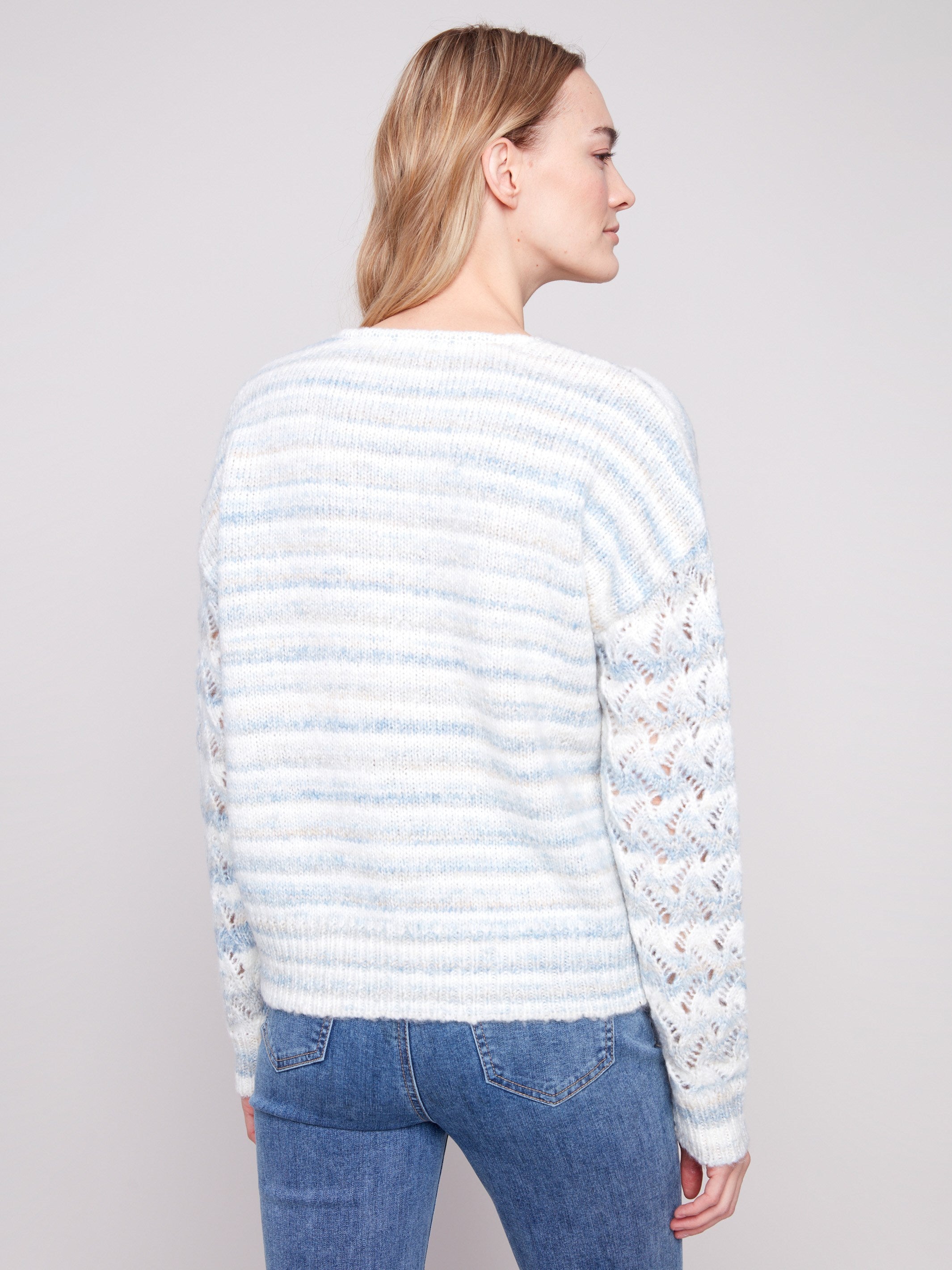 Open knit sleeves add flair to this women's space dye sweater, featuring drop shoulders and a chic V-neck by Charlie B.