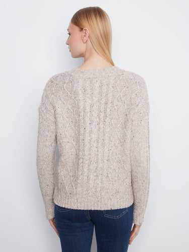 Speckled yarn gives the sweater a distinctive look that stands out effortlessly. By Charlie B.