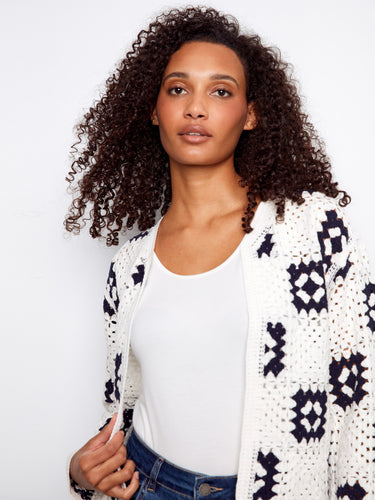Elegant white cardigan with a unique open front design and eye-catching geometric details by Charlie B.