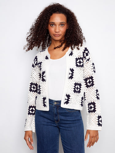 Fashionable white crochet cardigan with detailed geometric designs, adding flair to your look by Charlie B.
