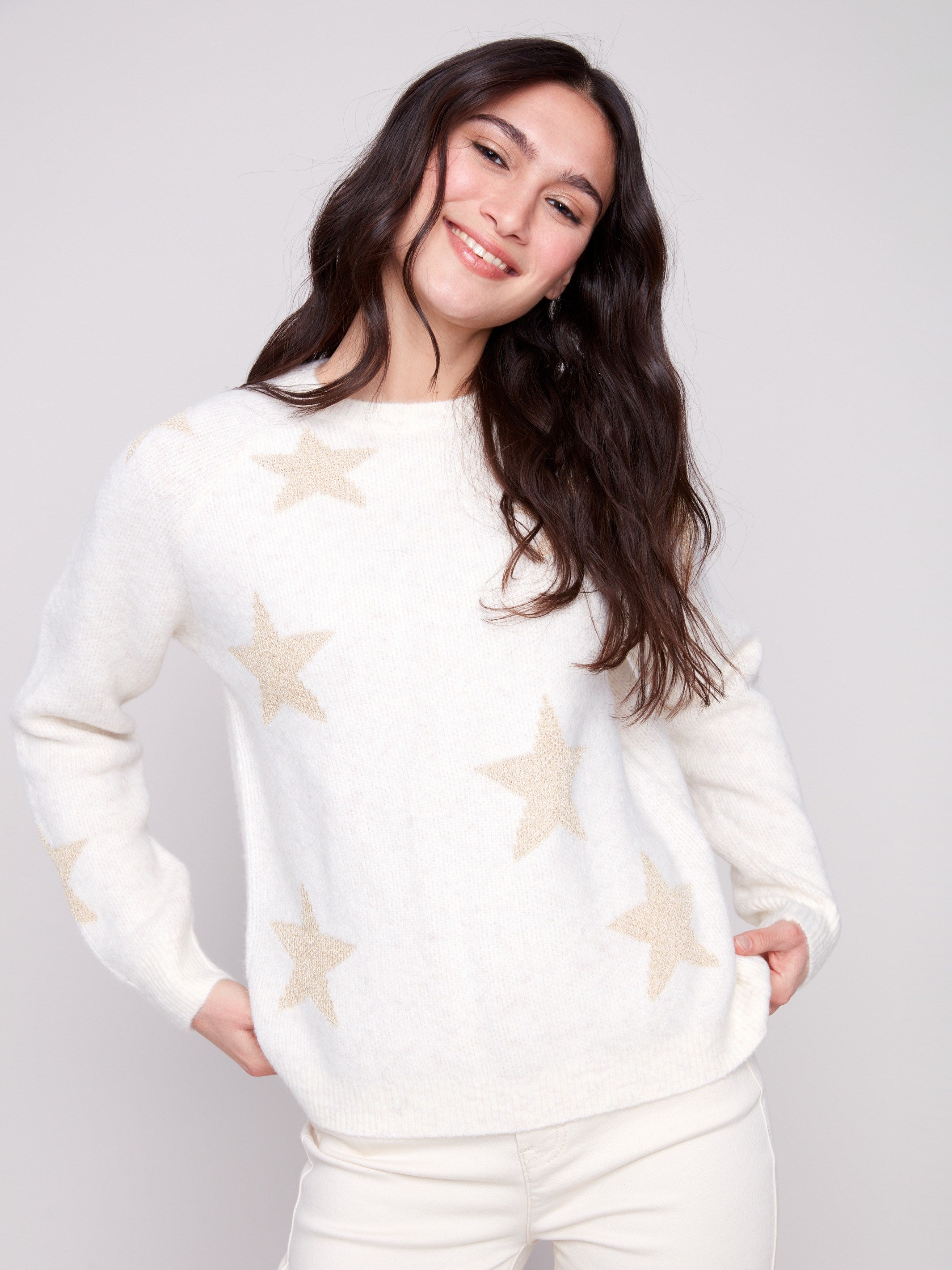 White sweater adorned with subtle metallic stars, crafted from plush knit material for a cozy feel by Charlie B.