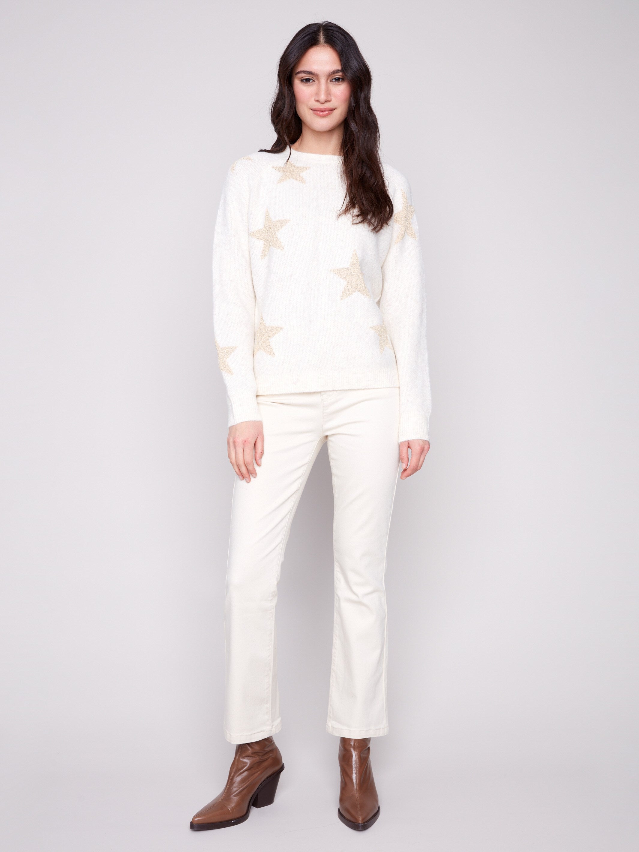 This white sweater features long raglan sleeves, offering a relaxed fit and stylish look by Charlie B.