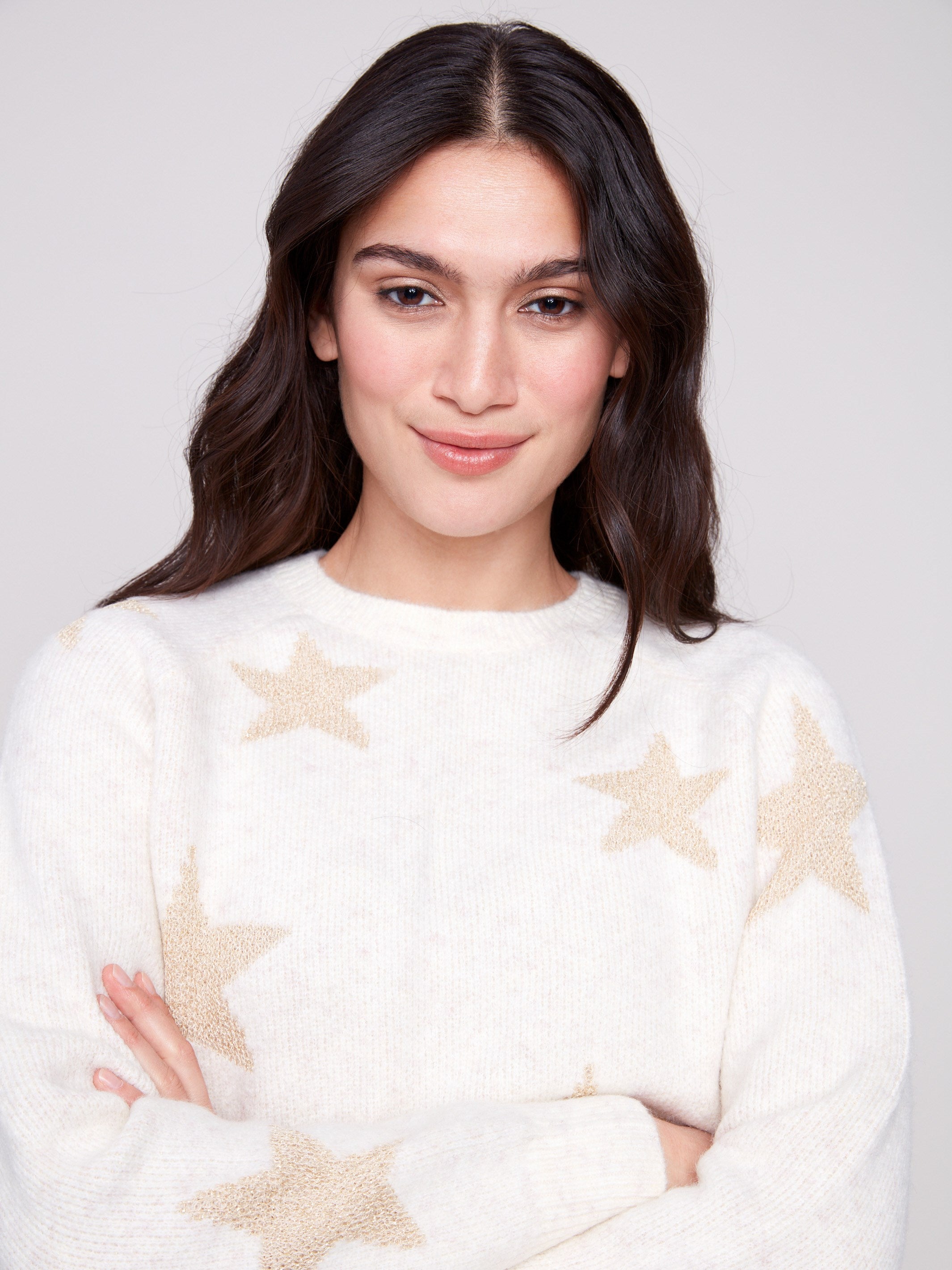 Plush knit white sweater highlighted by shimmering star accents, perfect for adding sparkle to any outfit by Charlie B.