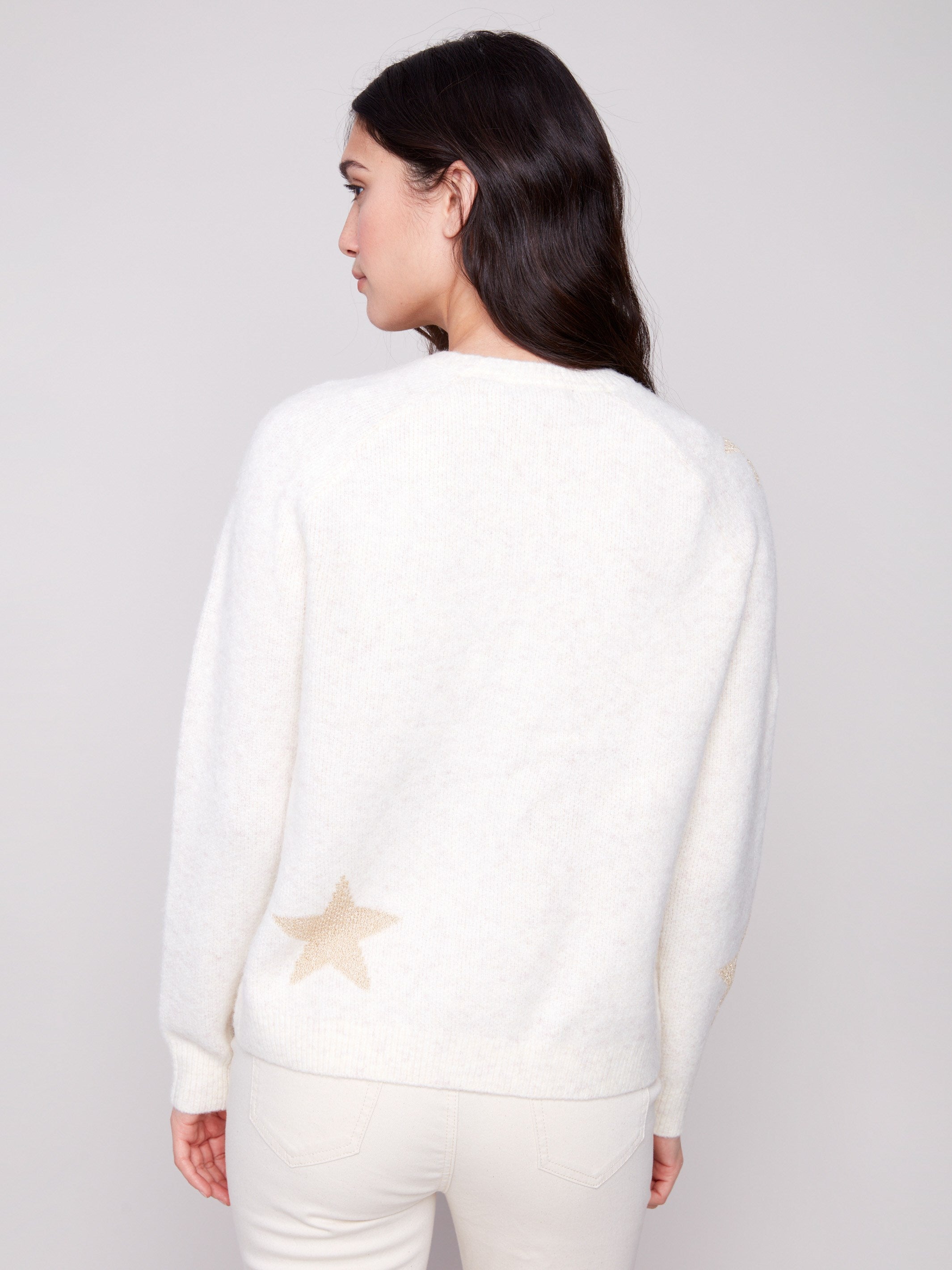 Elegant crew neck design on this plush knit white sweater with delicate star details by Charlie B.