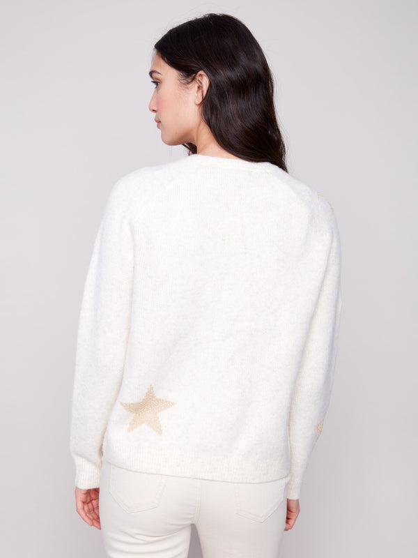 Elegant crew neck design on this plush knit white sweater with delicate star details by Charlie B.