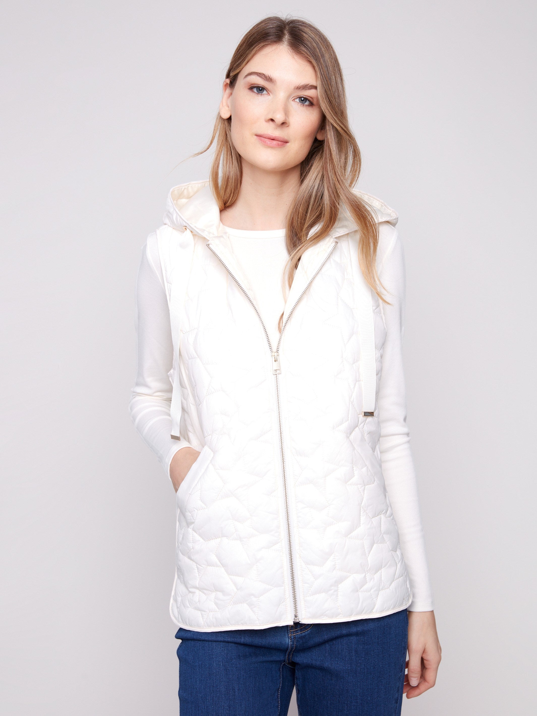Ecru vest with an attached hood and unique star quilting pattern, offering both fashion and function by Charlie B.