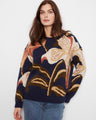 Navy blue sweater with an abstract floral design and a relaxed fit, showcasing ribbed cuffs for added comfort by Charlie B.