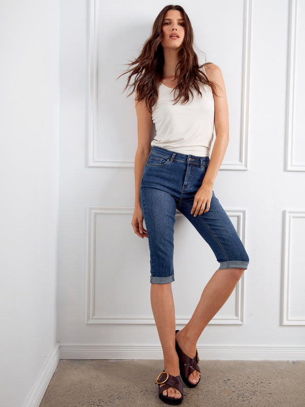 Model wearing light blue cuffed hem pedal pushers, crafted from comfortable stretch denim by Charlie B.