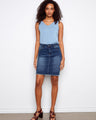 Denim skirt featuring a regular rise for comfortable wear, paired with a sleeveless top. Finished with frayed edges. By Charlie B.