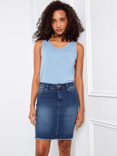 Showcasing a frayed edge denim skirt that adds an edgy touch to any outfit, complemented by a casual tank top. By Charlie B.