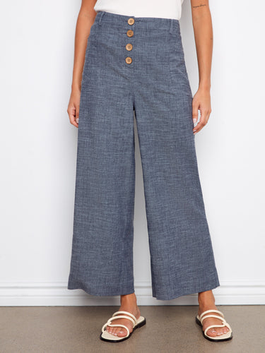 These indigo wide-leg pants offer a cropped length with a stylish button front, made of stretch linen by Charlie B.
