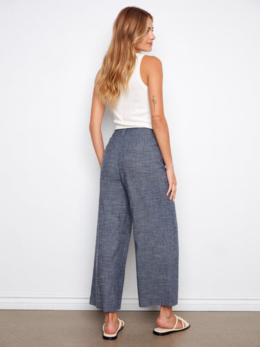 Indigo pants with patch pockets and wide-leg fit, designed in stretch linen for everyday ease by Charlie B.