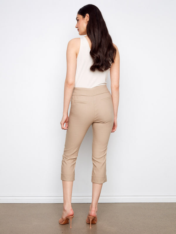Beige stretch fabric capri pants with cuffed hems, offering both style and flexibility for daily wear by Charlie B.