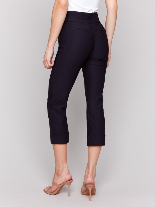 Navy capri pants showcasing elegant folded cuffs detail by Charlie B.