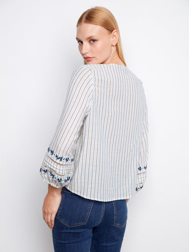 Chic striped blouse showcasing a front-tie style and beautiful sleeve embroidery in 100% cotton by Charlie B.