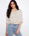 Striped shirt with a classic collar, featuring a stylish button-front closure for versatile wear. Designed by Charlie B.