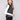 Black sweater vest featuring a crew neck and white stripes, ideal for layering with your favorite outfits by Charlie B.