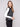 Black sweater vest featuring a crew neck and white stripes, ideal for layering with your favorite outfits by Charlie B.