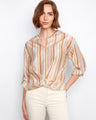 Elegant blouse with a twist front, featuring a unique striped pattern that adds sophistication to any look. Designed by Charlie B.
