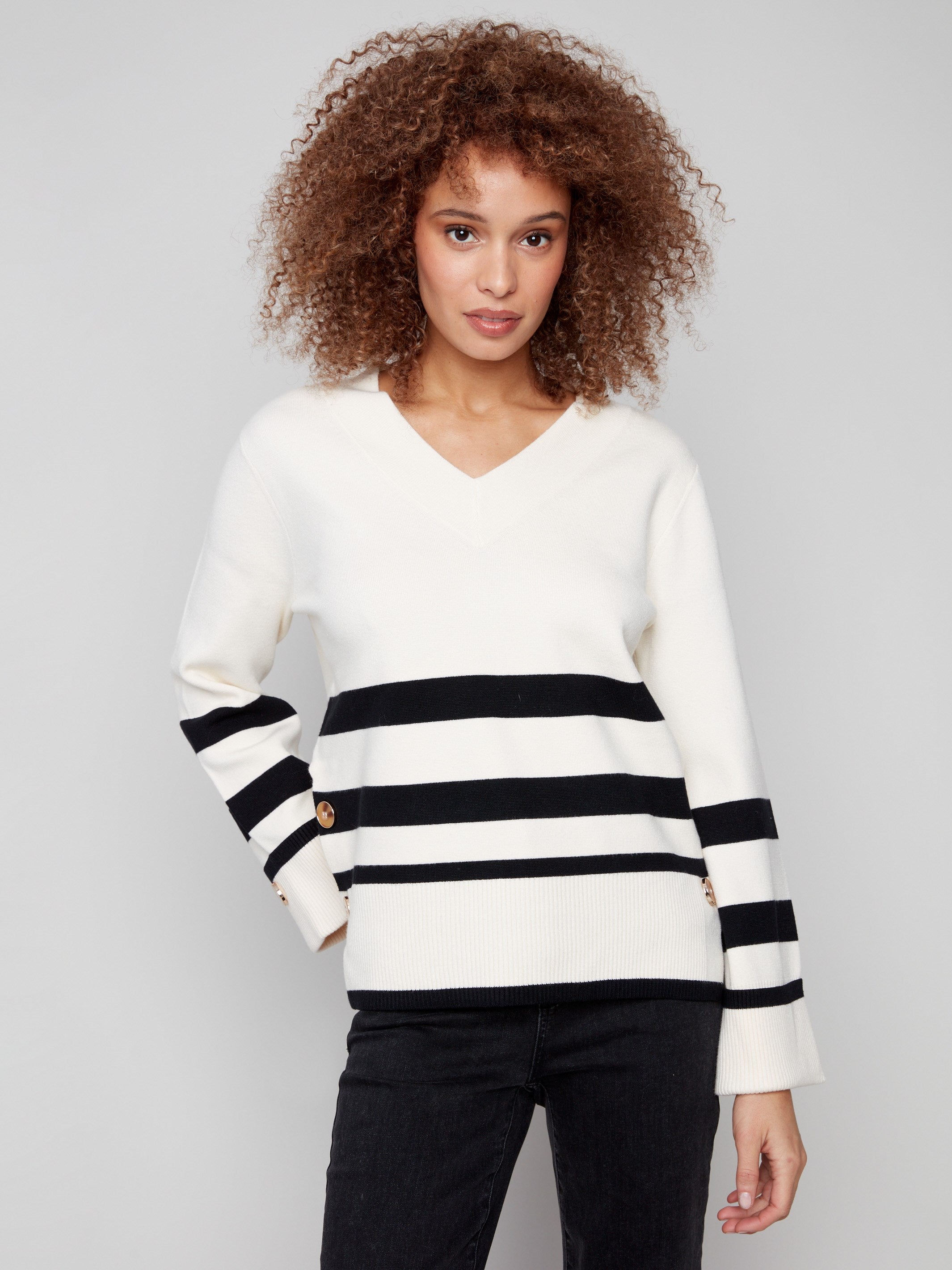 Ecru sweater featuring bold stripes and buttons at the sleeves, adding a chic touch to your wardrobe by Charlie B.