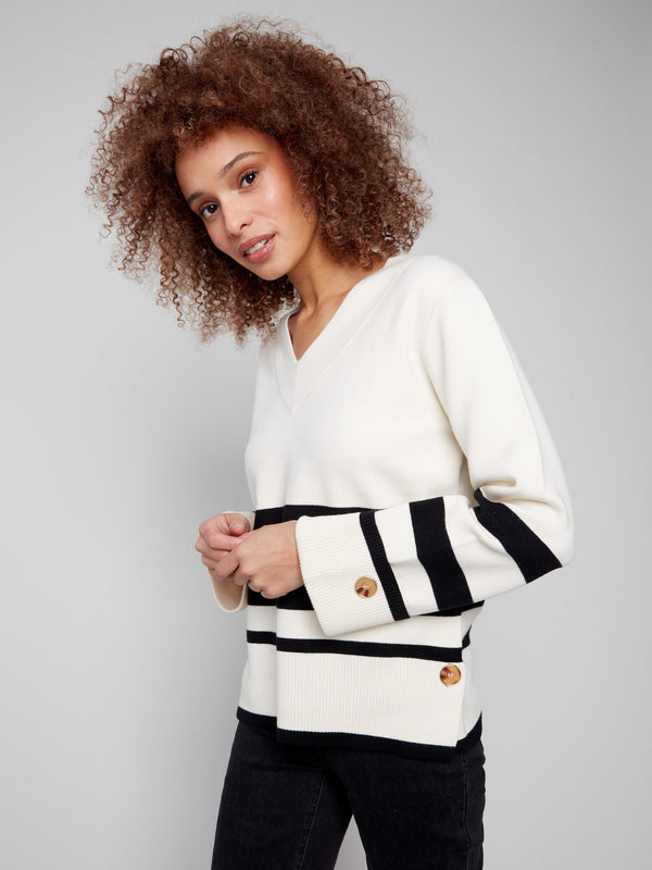 Elegant striped sweater in ecru with button details on the sides, offering a trendy yet classic style by Charlie B.