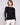 Elegant black sweater featuring crochet sleeves, perfect for a stylish look by Charlie B.