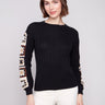 Elegant black sweater featuring crochet sleeves, perfect for a stylish look by Charlie B.