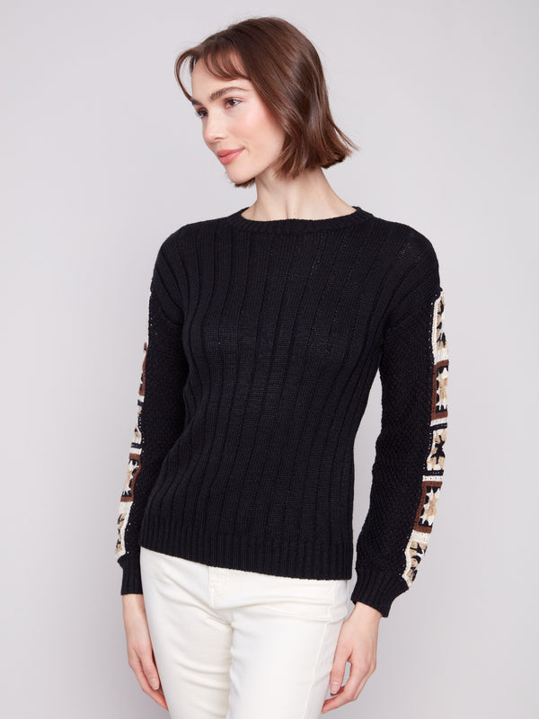 Sophisticated black sweater showcasing a crew neckline and artistic sleeve design by Charlie B.