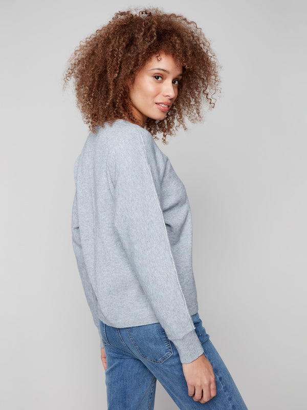 Elegant heather grey sweater showcasing metallic lurex detail on sleeves by Charlie B.