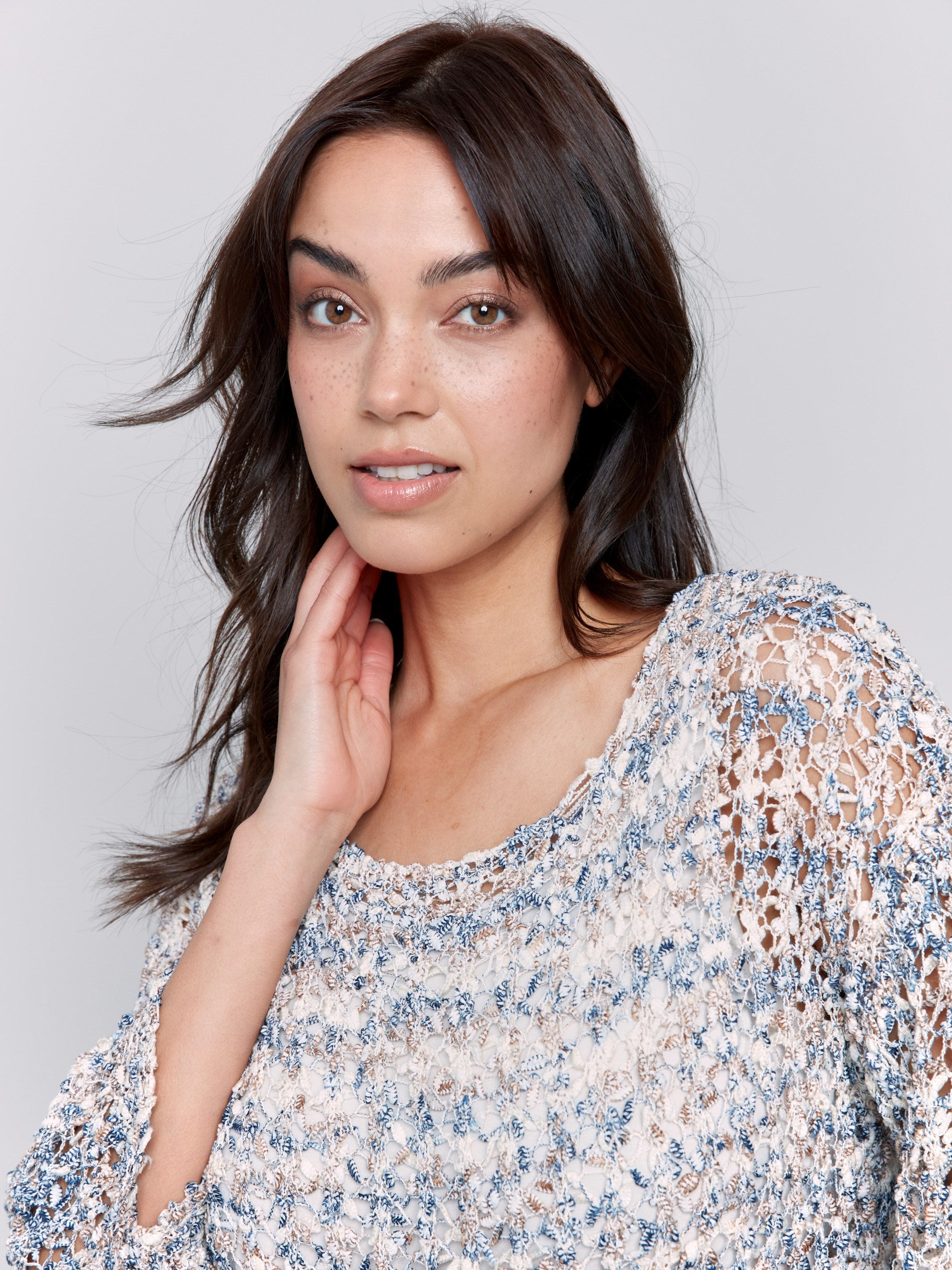 Long sleeve denim sweater with intricate open-knit pattern by Charlie B.