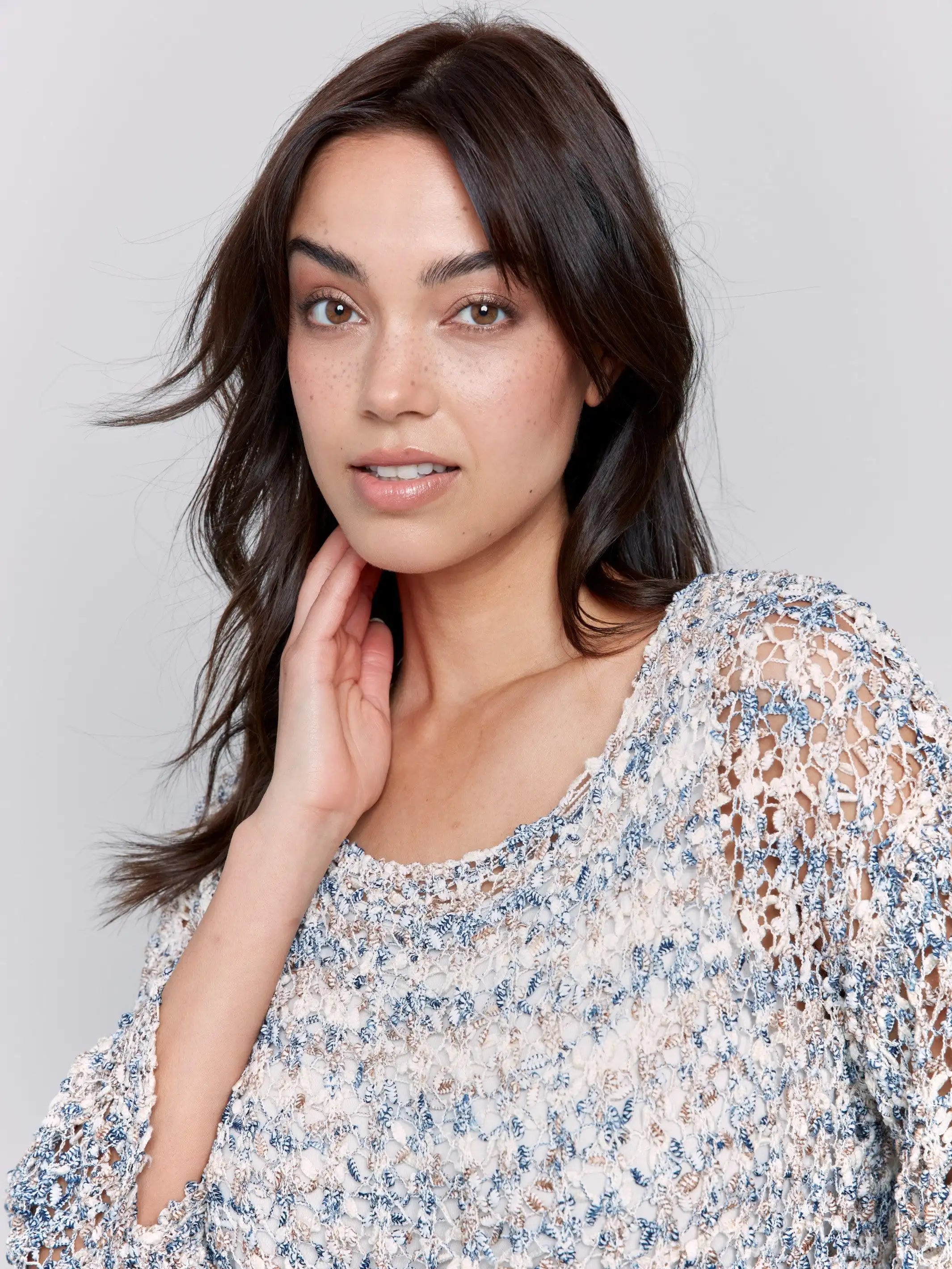 Long sleeve denim sweater with intricate open-knit pattern by Charlie B.