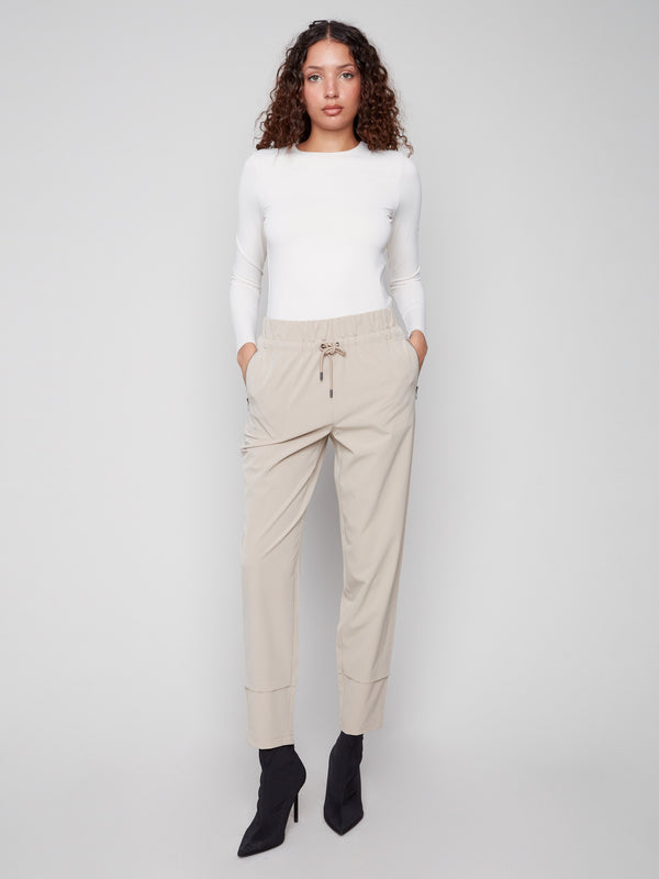 Greige slim-leg techno pants feature a relaxed fit and pull-on style, perfect for casual wear by Charlie B.