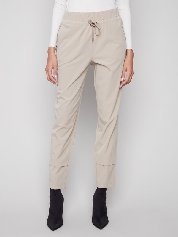 These greige pants have an elastic waistband with drawstring, offering comfort and style by Charlie B.