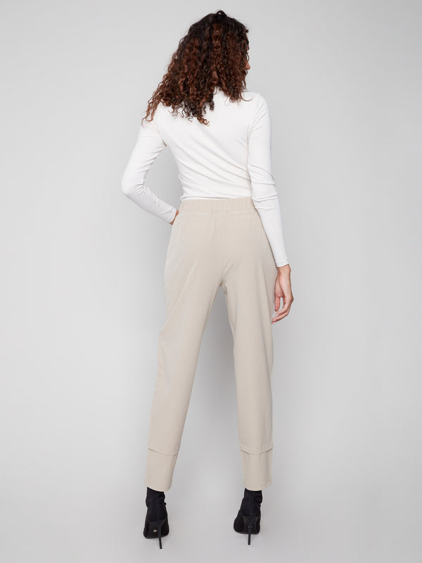 Greige slim-leg techno pants with adjustable waistband, side pockets, and drawcords by Charlie B.