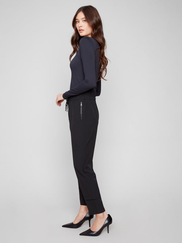 Cuff detail enhances the sleek design of these versatile black techno pants, ideal for any occasion by Charlie B.