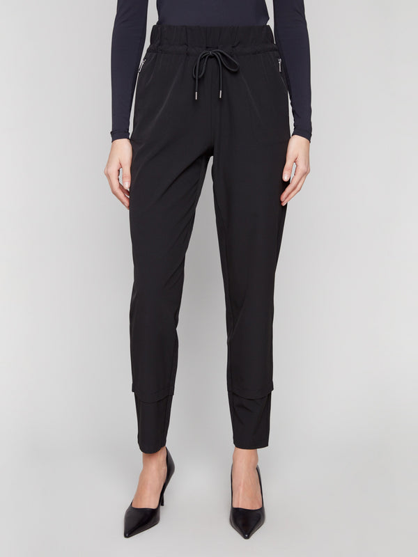 Black slim-leg techno pants with adjustable waistband, side pockets, and drawcords by Charlie B.