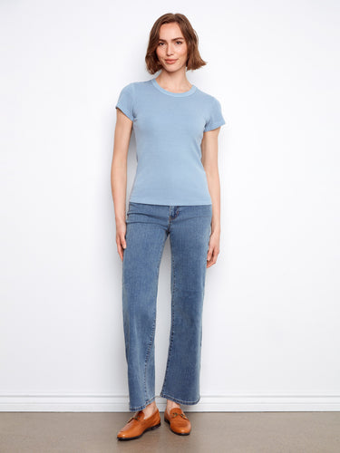 Embrace comfort with this semi-fitted blue top, designed to flatter and fit effortlessly. By Charlie B.